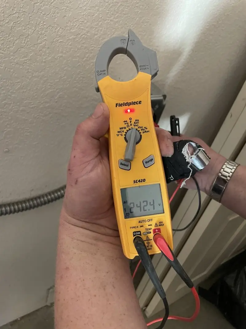 Voltage testing with clamp meter during Ceiling Fan Installation in California